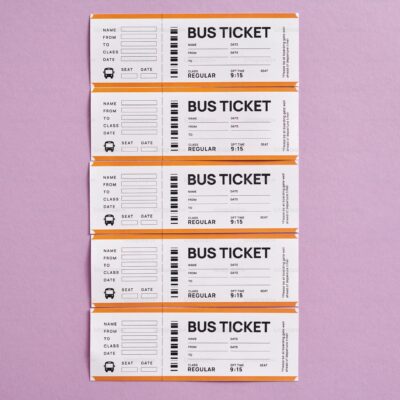 Photo of five bus tickets lined up against a purple background.